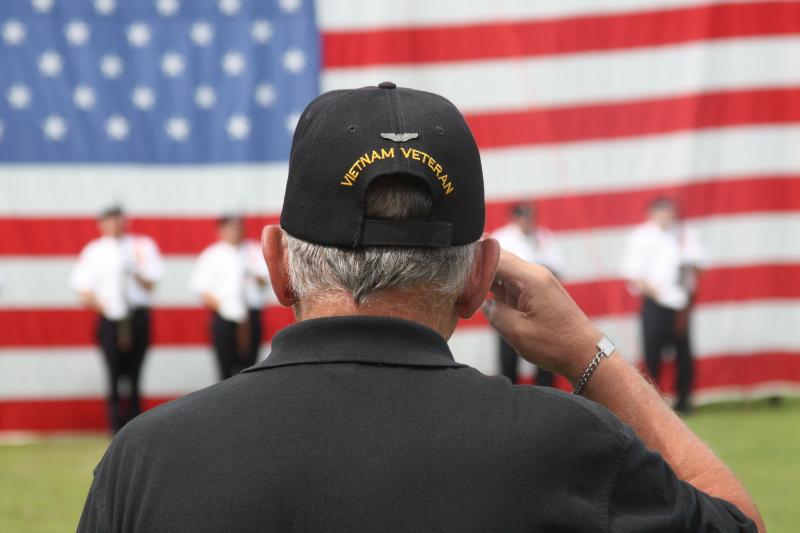 Vietnam veteran Chuck Sooy salutes as taps plays during the closing ceremony at The Moving Wall on Monday morning. BY MATTHEW BERNAT